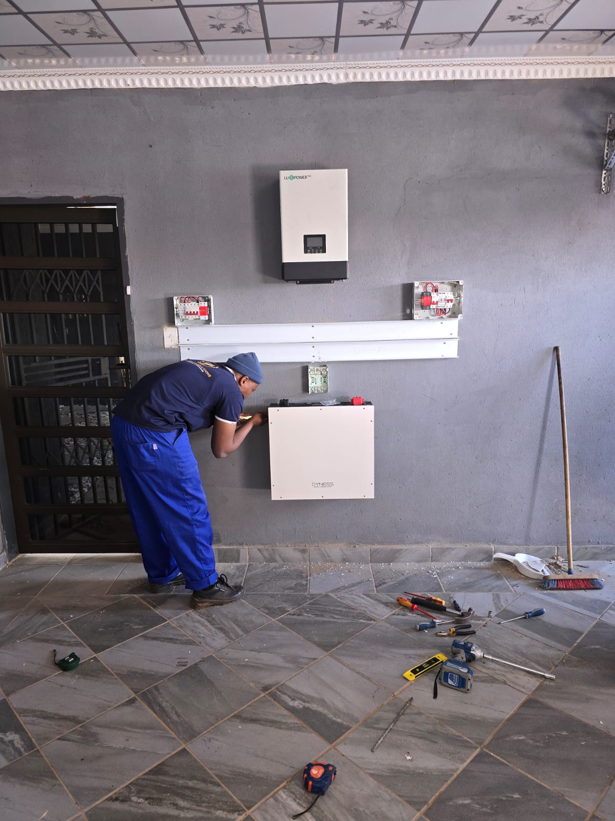 Kunax technician commissioning a solar inverter and battery system